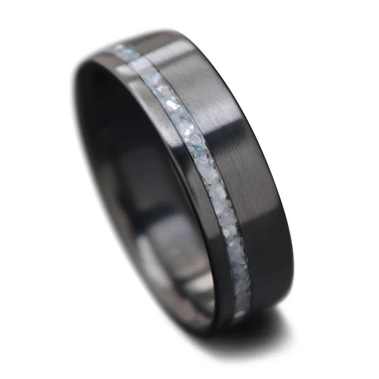 Black titanium wedding band with pearl inlay, 7mm mens wedding ring, polished flat profile, unique mens ring, free engraving available, displayed on a white background.