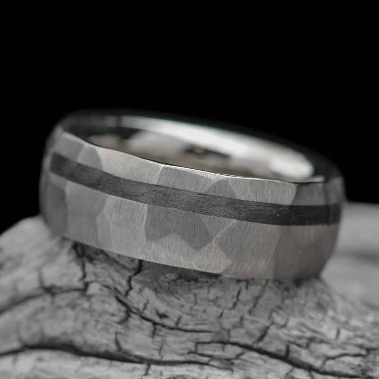 14KW mens wedding band with unidirectional inlay, faceted domed profile, 7mm width, custom ring with free engraving, displayed on a white sea branch.