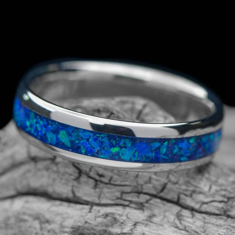 Platinum wedding band with blue opal inlay, 6mm mens ring, polished domed profile, unique design, free engraving, displayed on white sea branch.