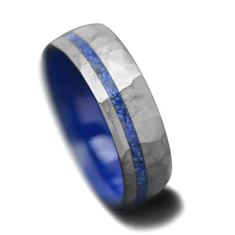 Faceted titanium wedding band with lapis lazuli inlay, 7mm mens domed ring, unique custom design, free engraving option, displayed on a white background.