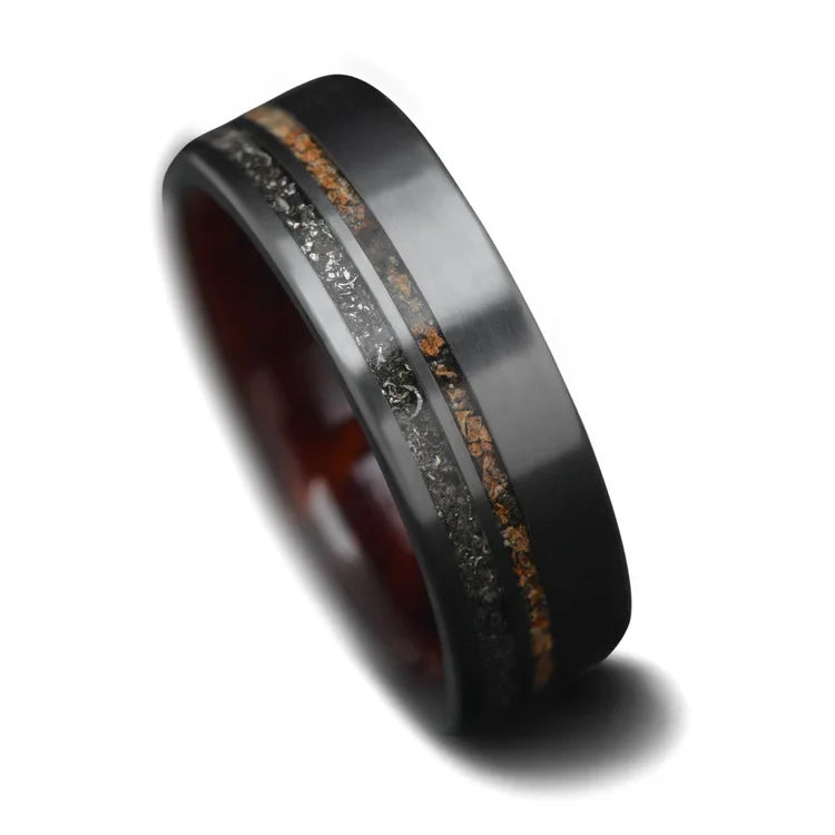 Black titanium wedding band featuring meteorite and crushed T-Rex inlays, 7mm mens matte flat profile ring, unique mens wedding ring with free engraving, displayed on a white background.