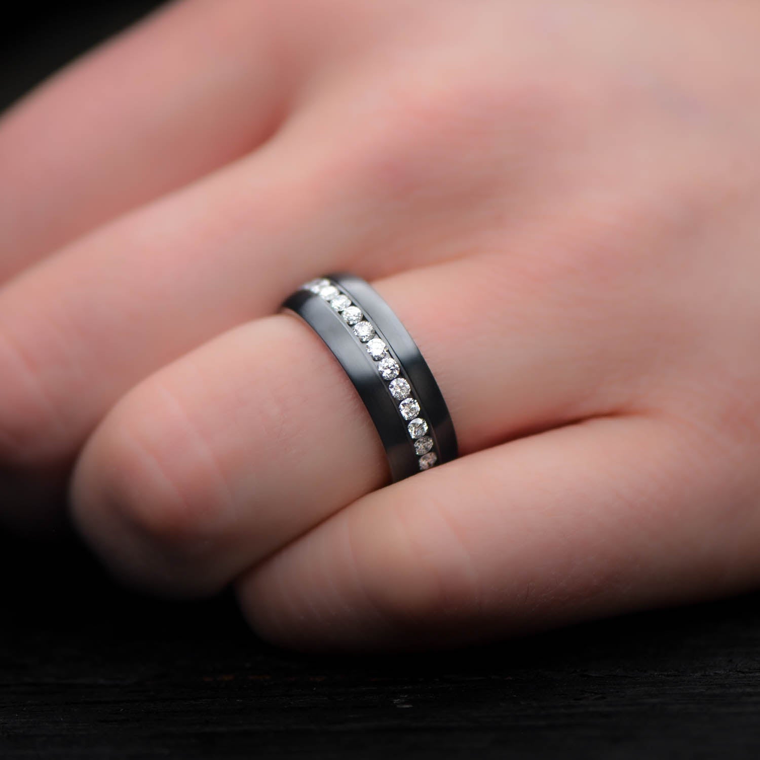 Zirconium wedding band with eternity set precious stones, mens 6mm brushed domed profile ring, displayed on a white sea branch, free engraving available.