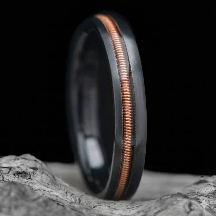 Black Titanium Wedding Band with Guitar String Inlay, 4mm, Custom Simple Ring, Unique Wedding Band, Free Engraving, displayed on white sea branch.