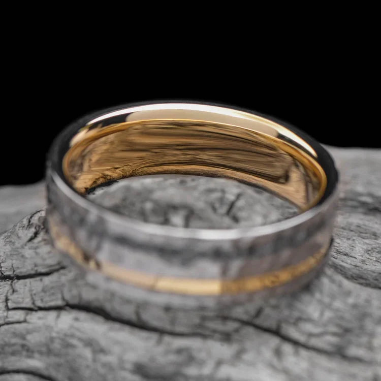 Titanium wedding band with 14K yellow gold and ashes inlays, featuring a faceted flat profile, displayed on a white sea branch, 7mm mens unique design ring with free engraving option.