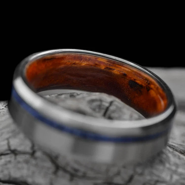 Titanium wedding band with lapis lazuli and amboyna inlays, featuring a brushed bevel profile, 6mm mens ring, displayed on a white sea branch, free engraving available.