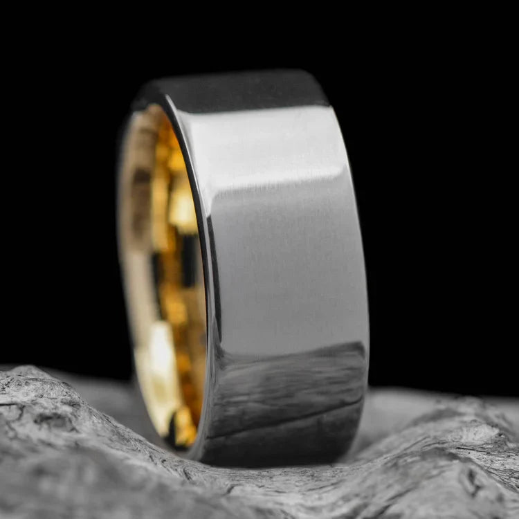 Titanium wedding band with 10KY inner sleeve, featuring a polished flat profile, 9mm mens ring, displayed on a white sea branch, free engraving available.