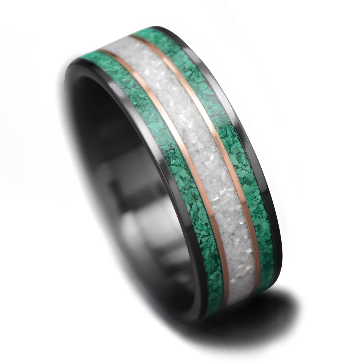 Black titanium wedding band with dual 14K yellow gold inlays and pearl center, 8mm mens ring, custom design, free engraving, displayed on white sea branch.