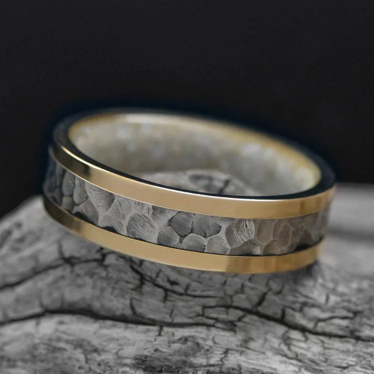 14KY gold wedding band with central 14KW gold inlay and pearl inner sleeve, mens 6mm hammered flat profile ring, unique design, free engraving, displayed on a white sea branch.