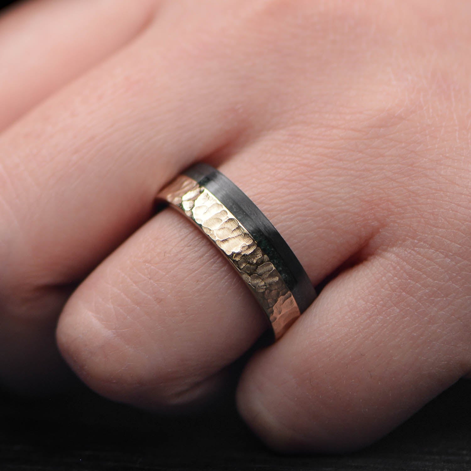 14KY mens wedding band featuring unidirectional and moss agate inlays, 7mm hammered flat profile, unique design with free engraving, displayed on a white background