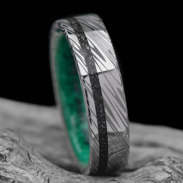 Heimskringla wedding band featuring meteorite and malachite inlays, 6mm mens unique custom ring with free engraving, displayed on a white sea branch.