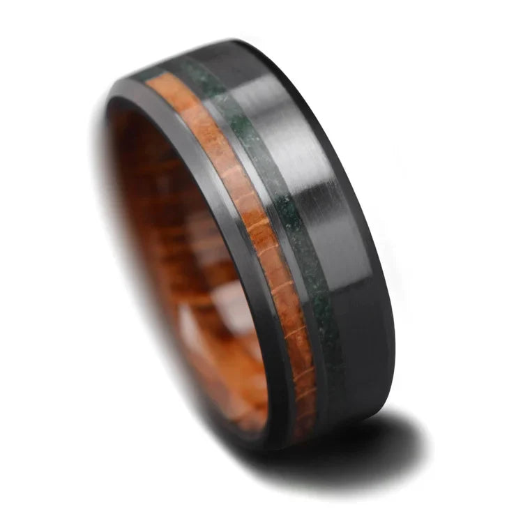 Black titanium wedding band featuring whiskey barrel oak and moss agate inlays, 8mm mens ring with unique custom design, free engraving available, displayed on a white background.