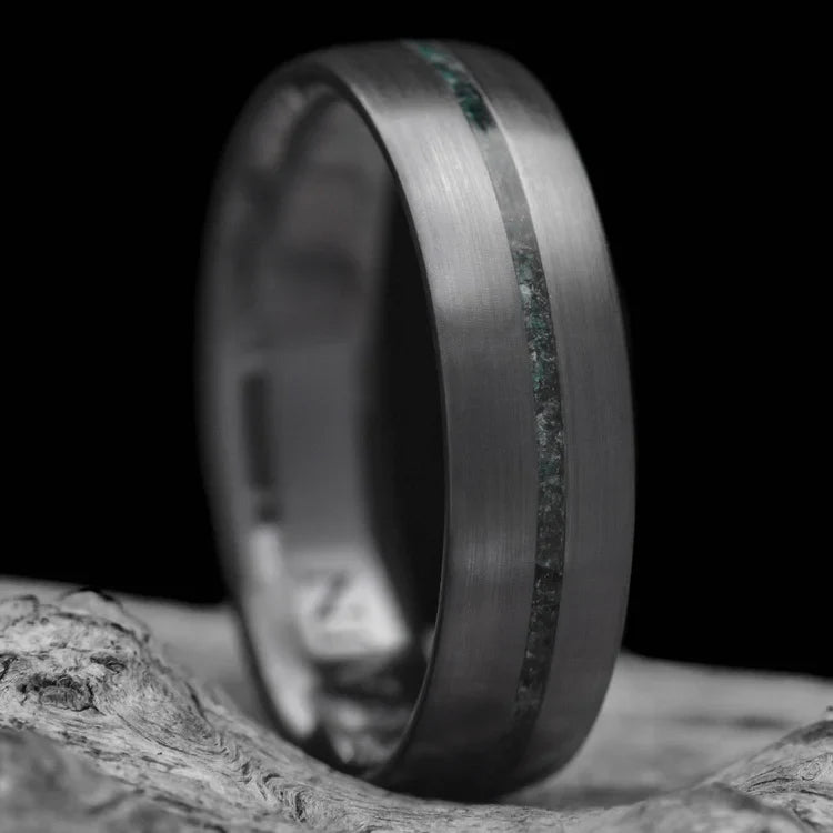 Zirconium wedding band with central moss agate inlay, 6mm mens ring, unique design, free engraving, displayed on white sea branch.