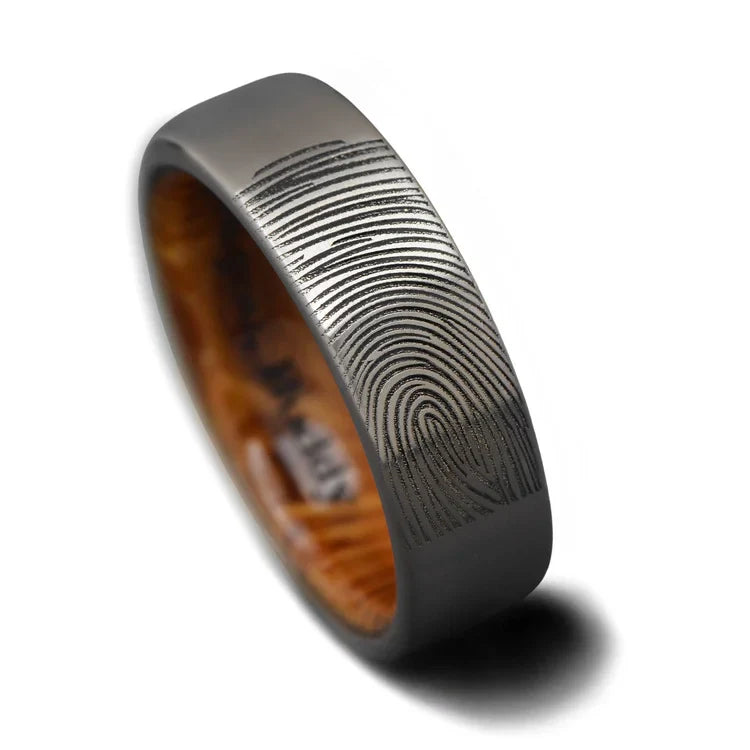 Mens 7mm titanium wedding band with whiskey barrel oak inner sleeve, featuring a brushed flat profile, available with free engraving, displayed on a white background.