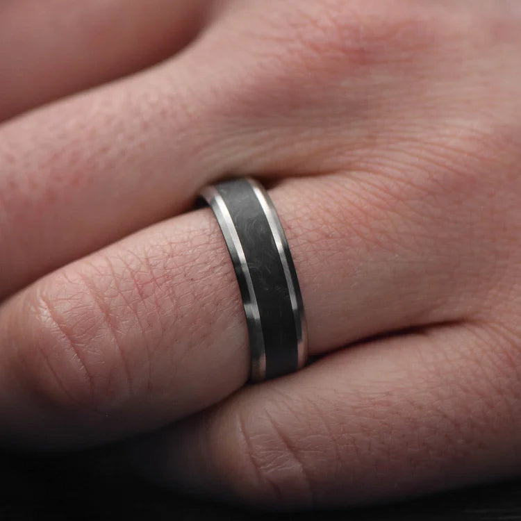 Titanium wedding band with central forged inlay, free engraving, 7mm mens wedding ring, brushed bevel profile, displayed on white sea branch.