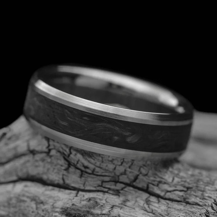 Titanium wedding band with central forged inlay, free engraving, 7mm mens wedding ring, brushed bevel profile, displayed on white sea branch.
