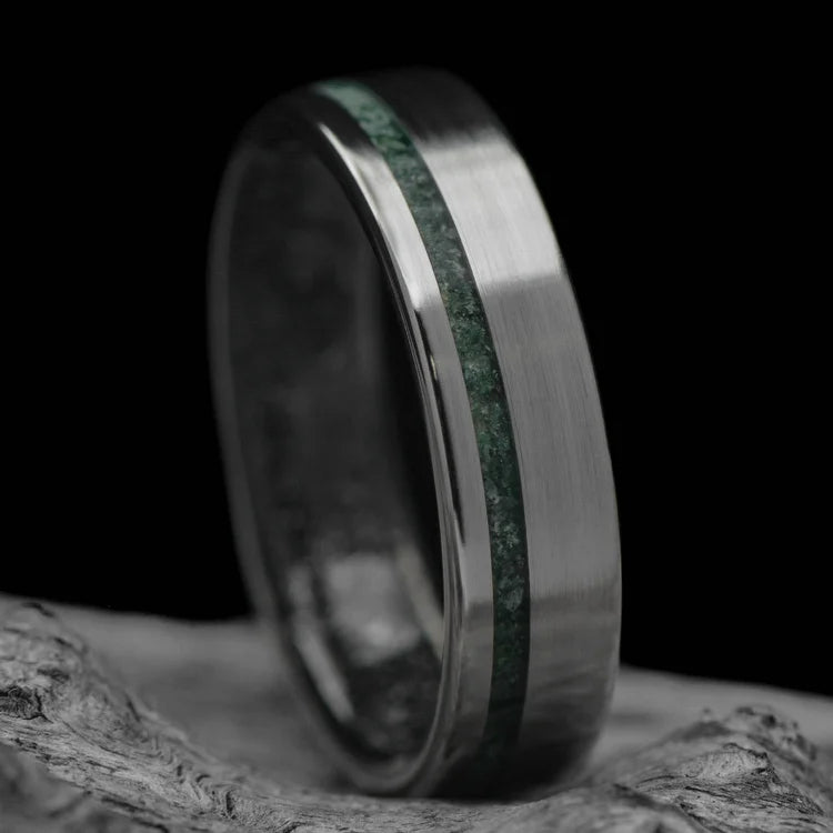 Titanium wedding band with moss agate and meteorite inlay, 6mm mens ring, unique brushed flat profile, free engraving, displayed on white sea branch.