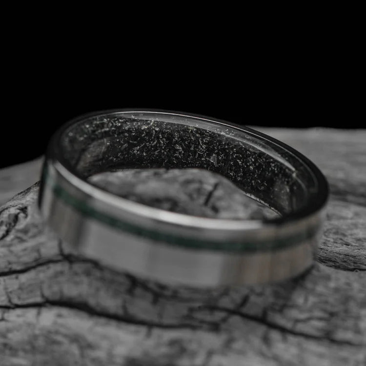 Titanium wedding band with moss agate and meteorite inlay, 6mm mens ring, unique brushed flat profile, free engraving, displayed on white sea branch.