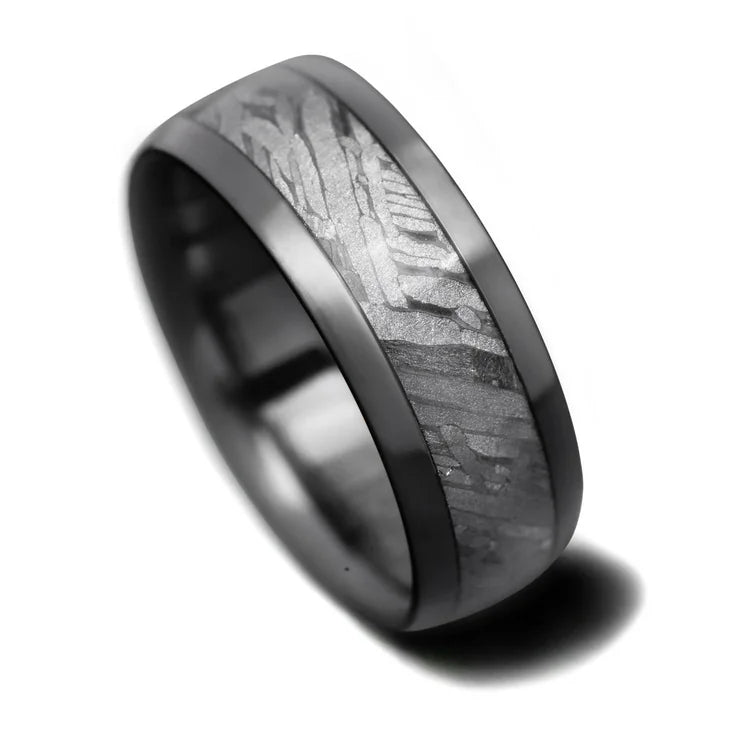 Black titanium mens wedding band with solid meteorite central inlay, 8mm width, unique design, free engraving available, displayed on a white background.