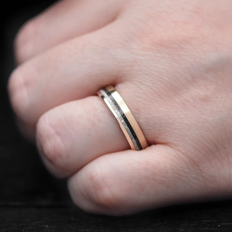 14K yellow gold wedding band with pearl and meteorite inlays on a hand, brushed flat profile, 5mm width, custom simple design, unique wedding ring with free engraving option.