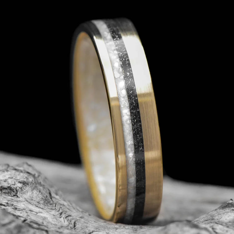 14K yellow gold wedding band with pearl and meteorite inlays, brushed flat profile, 5mm width, unique custom simple ring, free engraving available, displayed on a white sea branch, perfect for a unique wedding band choice.