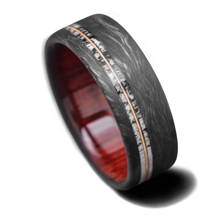 Mens 8mm wedding band featuring brushed flat design, dual deer antler and central guitar string inlays, bloodwood sleeve, available with free engraving, displayed on white background.
