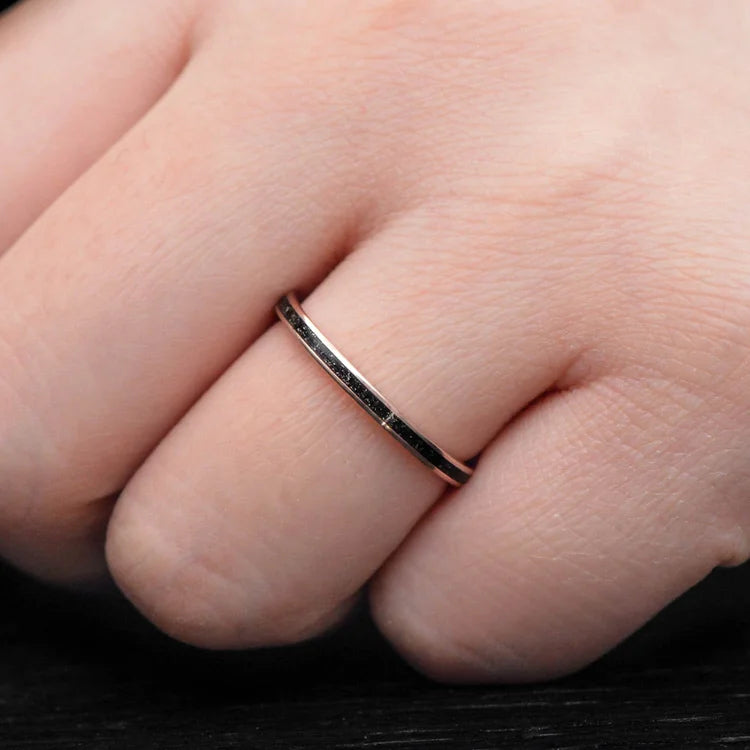 14K rose gold wedding band with central meteorite inlay on a womans hand, featuring a unique custom design, 2mm width, free engraving available, perfect for a distinctive and elegant womens wedding ring.