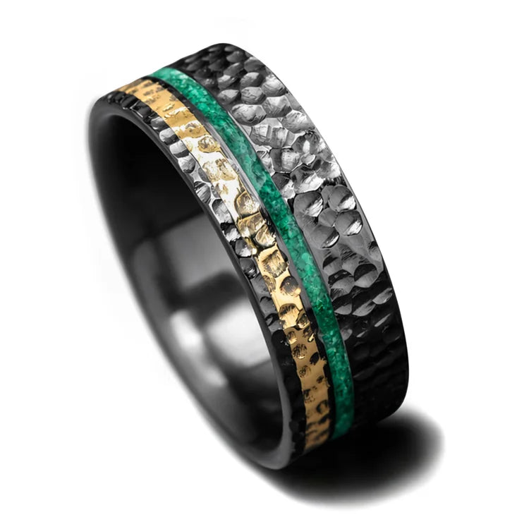 Black titanium wedding band featuring 18k yellow gold and malachite inlays, 8mm mens ring with a hammered flat profile, unique design, free engraving option, displayed on a white background.
