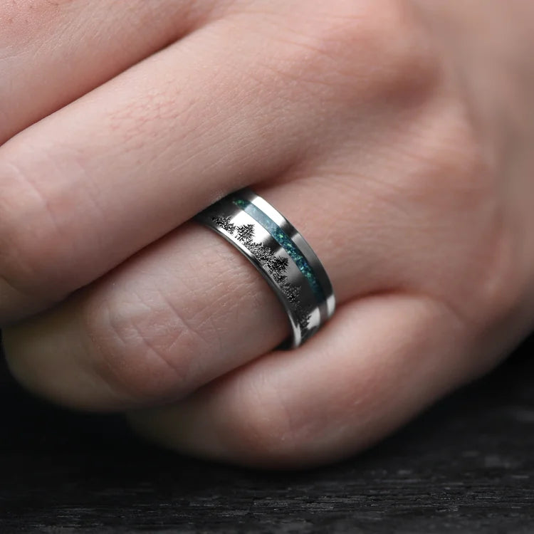 Mens titanium wedding band with black emerald opal inlay, 7mm, shown on a hand, unique design with free engraving option.