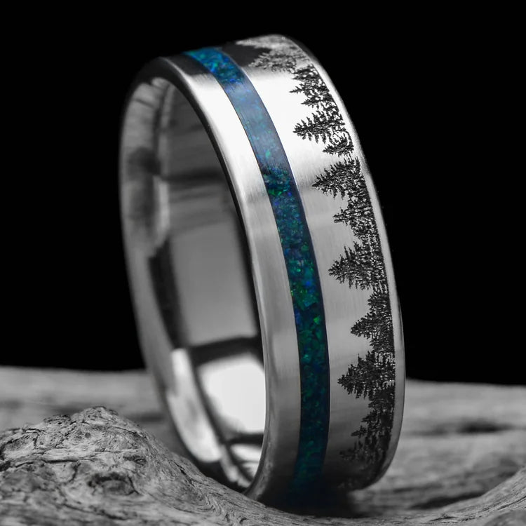 Titanium wedding band with black emerald opal inlay, 7mm mens ring, unique design, free engraving, displayed on white sea branch.
