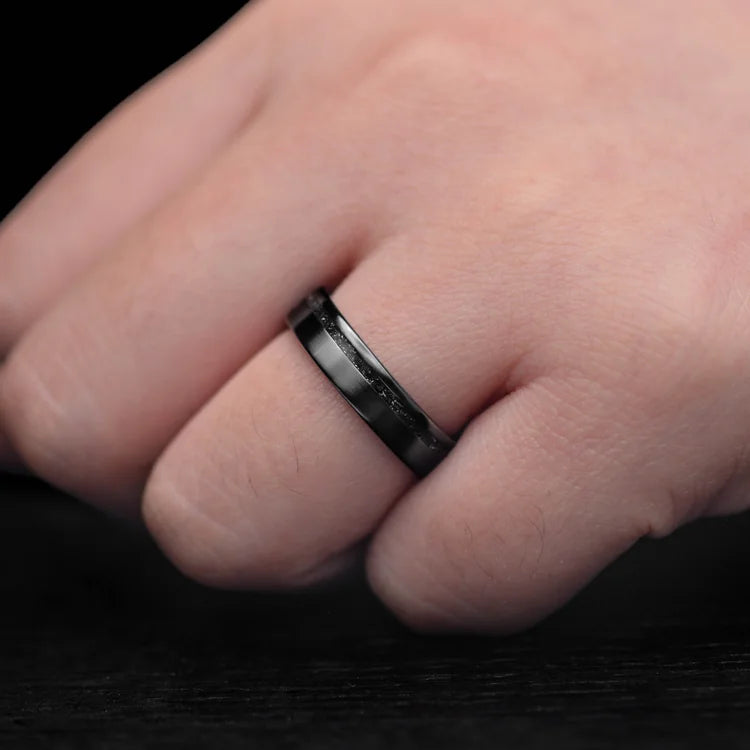 Black titanium wedding band with meteorite inlay on hand, 5mm custom flat brushed ring, unique simple design, free engraving available.