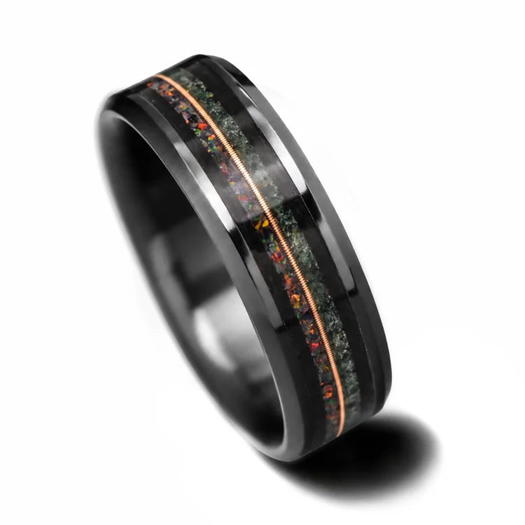Black Titanium Wedding Band with Moss Agate and Black Fire Opal Inlays featuring a Central Forged Guitar Detail, 7mm Mens Wedding Ring on a white background, available with free engraving.