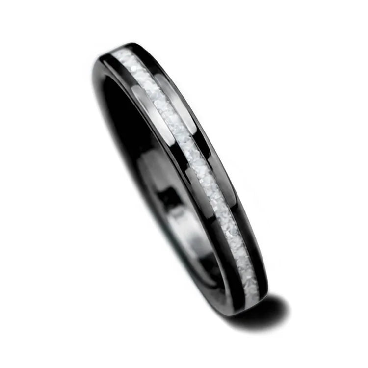 Black titanium wedding band with central pearl inlay, 3mm womens wedding ring, polished flat profile, custom bridal design, available with free engraving, displayed on a white background.