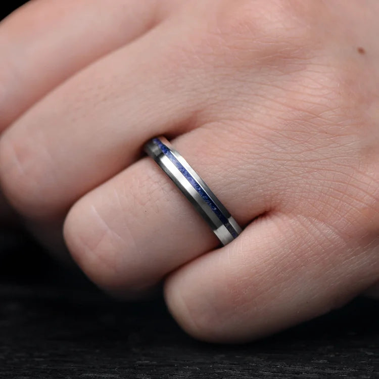 Titanium wedding band with lapis lazuli inlay and whiskey barrel oak sleeve on hand, 4mm brushed bevel profile, custom simple ring with free engraving.