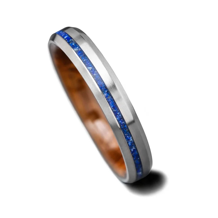 Titanium wedding band with lapis lazuli inlay and whiskey barrel oak sleeve, featuring a brushed bevel profile, 4mm width, custom simple design, free engraving option, displayed on a white background.