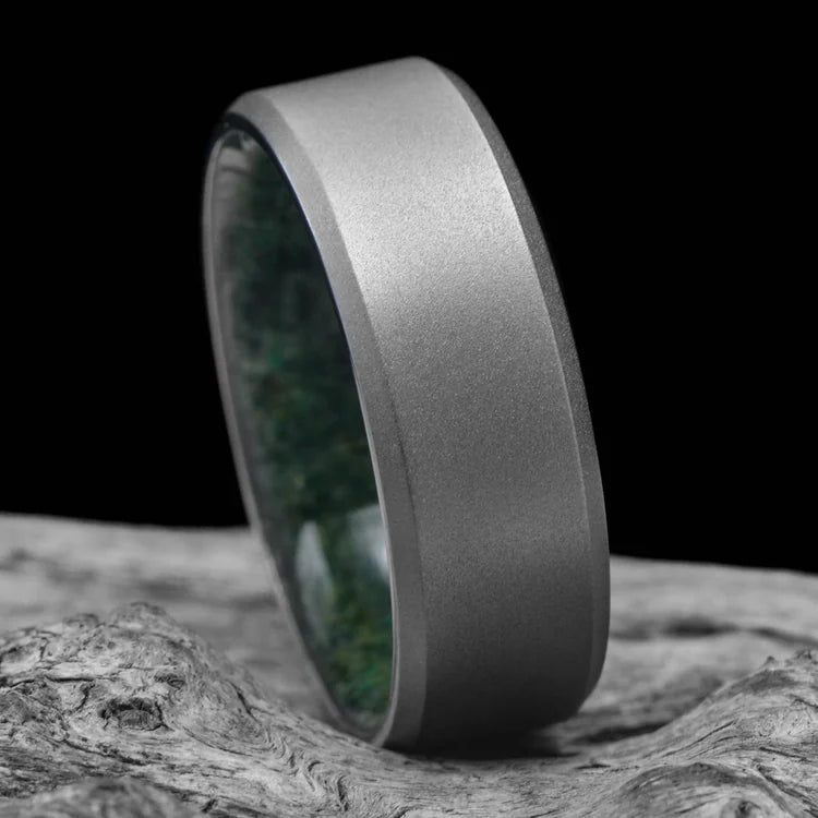 Titanium wedding band with moss agate inner sleeve, sandblasted bevel profile, 8mm mens ring on white sea branch, unique mens wedding ring, free engraving available.