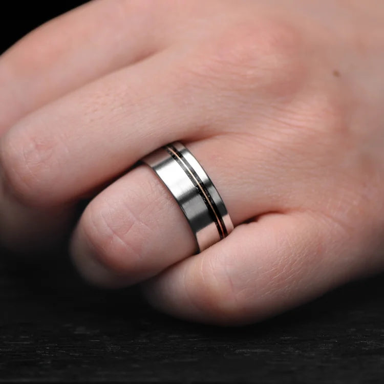 Mens 8mm titanium wedding band with black onyx and guitar string inlay, brushed flat profile, worn on a hand, unique mens ring with free engraving.