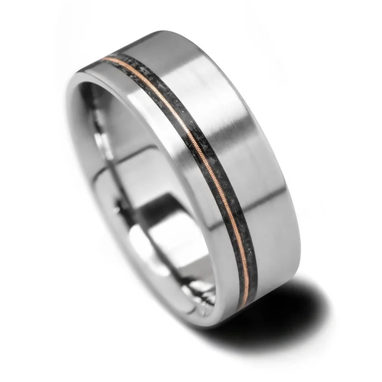 Titanium wedding band featuring black onyx and guitar string inlay, 8mm mens ring with brushed flat profile, free engraving available, unique design on white background.