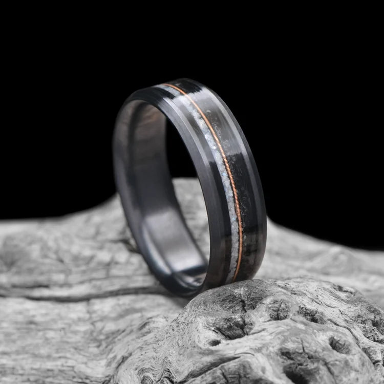 Black Titanium Wedding Band with Pearl & Black Onyx Inlays, 7mm Men's Wedding Ring, Beveled Profile, Polished Finish, Free Engraving, displayed on white sea branch.