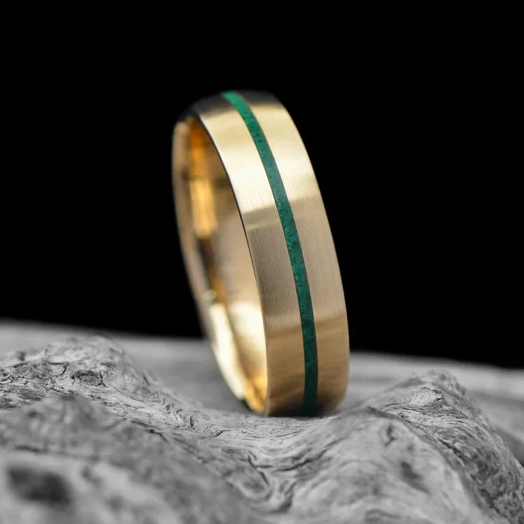 14K Yellow Gold Men's Wedding Band with Central Malachite Inlay, Brushed Domed Profile, 6mm Width, Customizable with Free Engraving, Ring Displayed on White Sea Branch