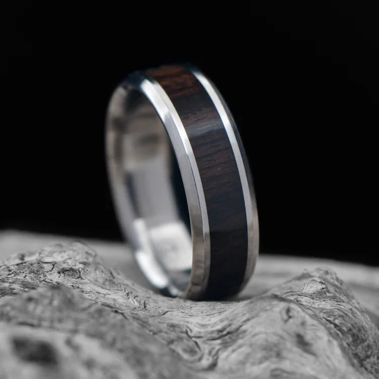 Titanium Wedding Band with Central African Blackwood Inlay, 7mm Men's Ring, Polished Beveled Profile, Free Engraving, displayed on white sea branch