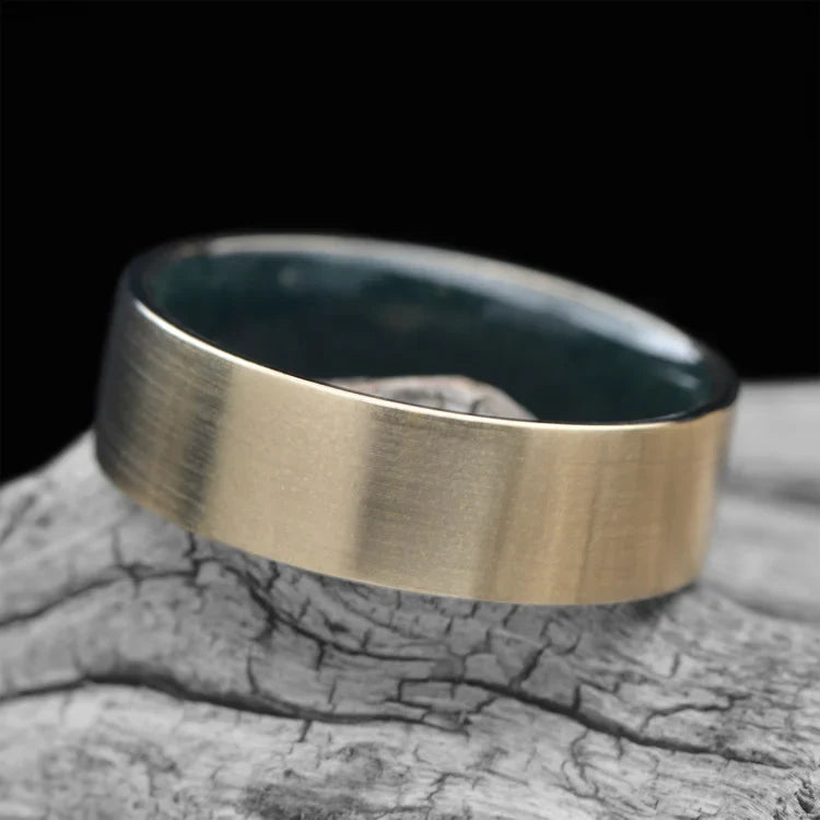 10KY wedding band with moss agate inner sleeve on a white sea branch, featuring free engraving, 7mm width, unique custom men's wedding ring.