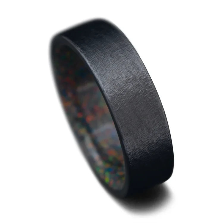 Black Titanium Wedding Band with Black Fire Opal Inner Sleeve, featuring a unique granite finish, 7mm men's wedding ring, free engraving option, displayed on a white background.