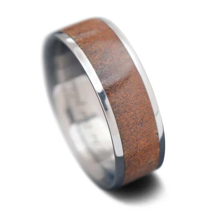 Men's 7mm titanium wedding band with central dinobone inlay, unique custom design, free engraving available, displayed on a white background.