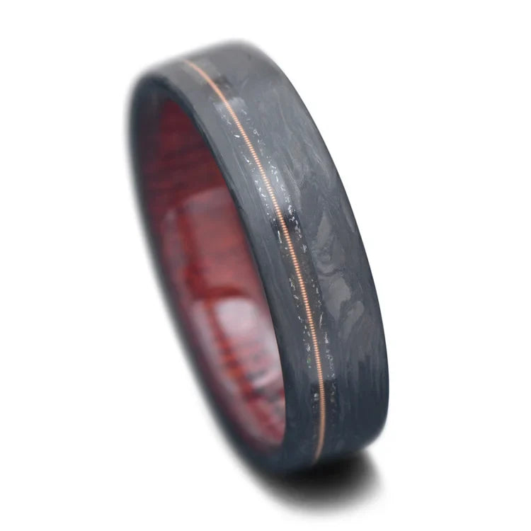 Forged wedding band with meteorite and guitar string inlay, bloodwood inner sleeve, men's matte flat profile ring, 6mm, free engraving, displayed on a white background.