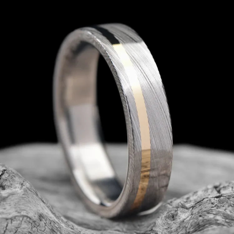 Heimskringla Wedding Band with 14KY Inlay and Titanium Inner Sleeve, 6mm Mens Ring, Polished Flat Profile, displayed on a white sea branch, free engraving available.