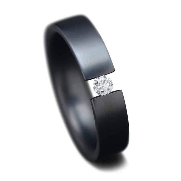 Black titanium wedding band with tension set diamond, 5mm width, custom unique wedding ring, free engraving option, displayed on a white background.