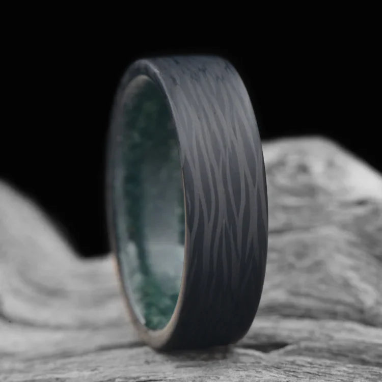 Cross-Cut Wave Wedding Band with Moss Agate Inner Sleeve, 7mm Men's Ring, Unique Brushed Domed Profile, Free Engraving, displayed on white sea branch.