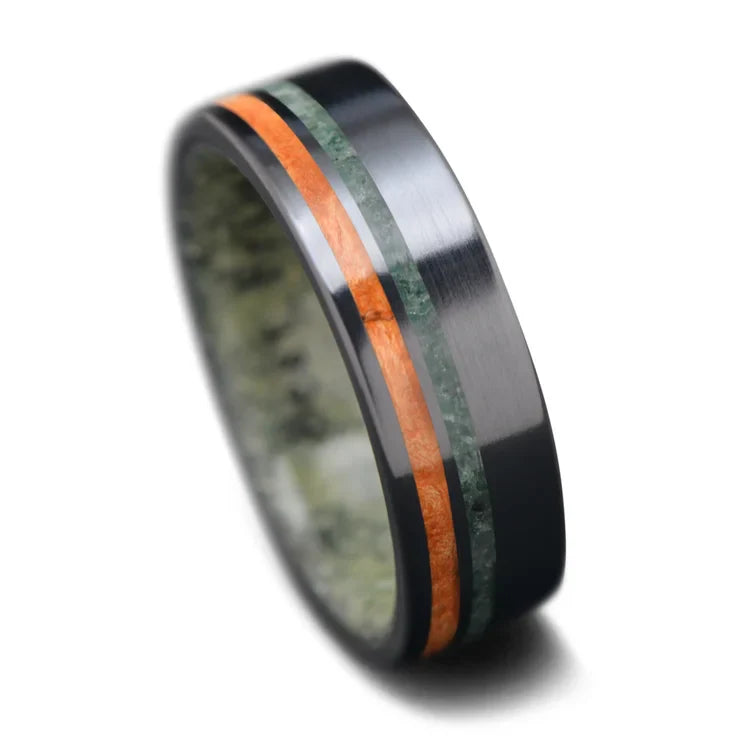 Men's unique black titanium wedding band with Western maple burl and moss agate inlays, featuring a jade inner sleeve, 7mm width, free engraving option, on a white background.