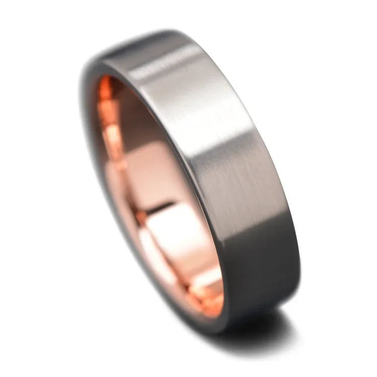 Titanium wedding band with 10K rose gold inner sleeve, 7mm wide, featuring a brushed flat profile, available for free engraving, mens unique wedding ring on a white background.