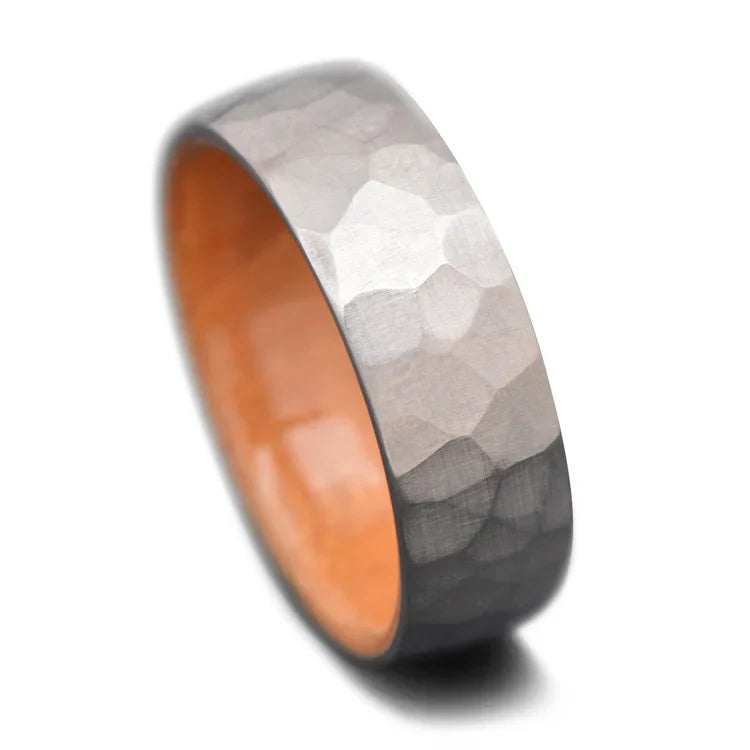 Faceted titanium wedding ring with birds eye maple inner sleeve, 7mm mens band, unique design, free engraving option on white background.